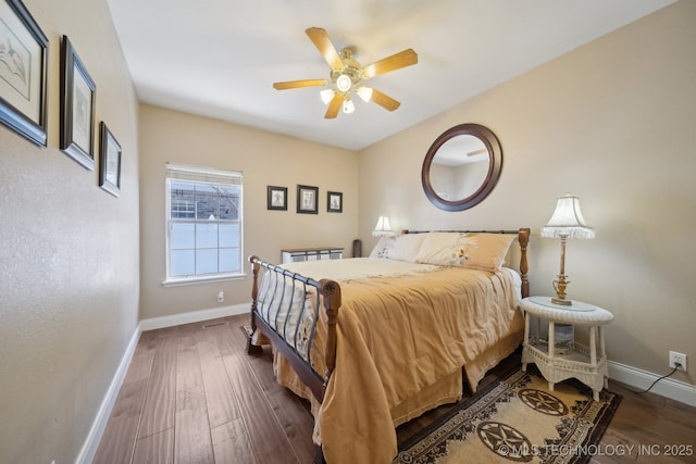 bedroom with ceiling fan and dark wood-type flooring