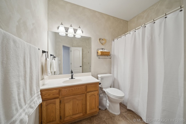 bathroom with vanity, toilet, and tile patterned floors