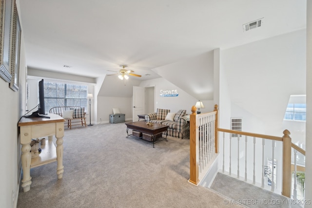 carpeted living room with vaulted ceiling and ceiling fan