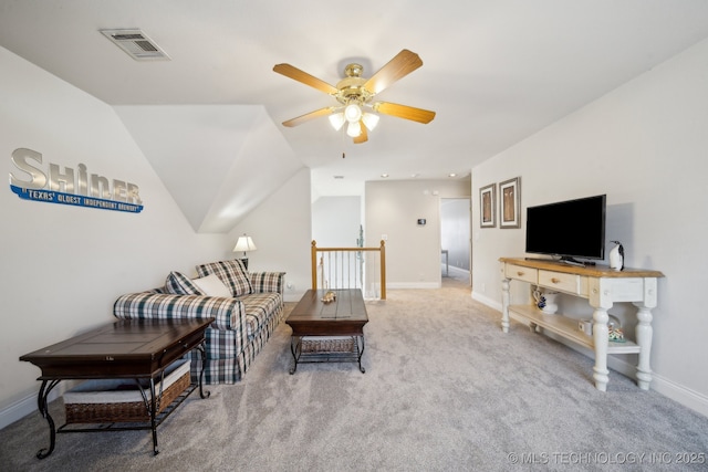 living room with carpet floors, vaulted ceiling, and ceiling fan