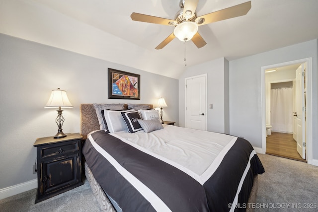 carpeted bedroom featuring ceiling fan, connected bathroom, and vaulted ceiling