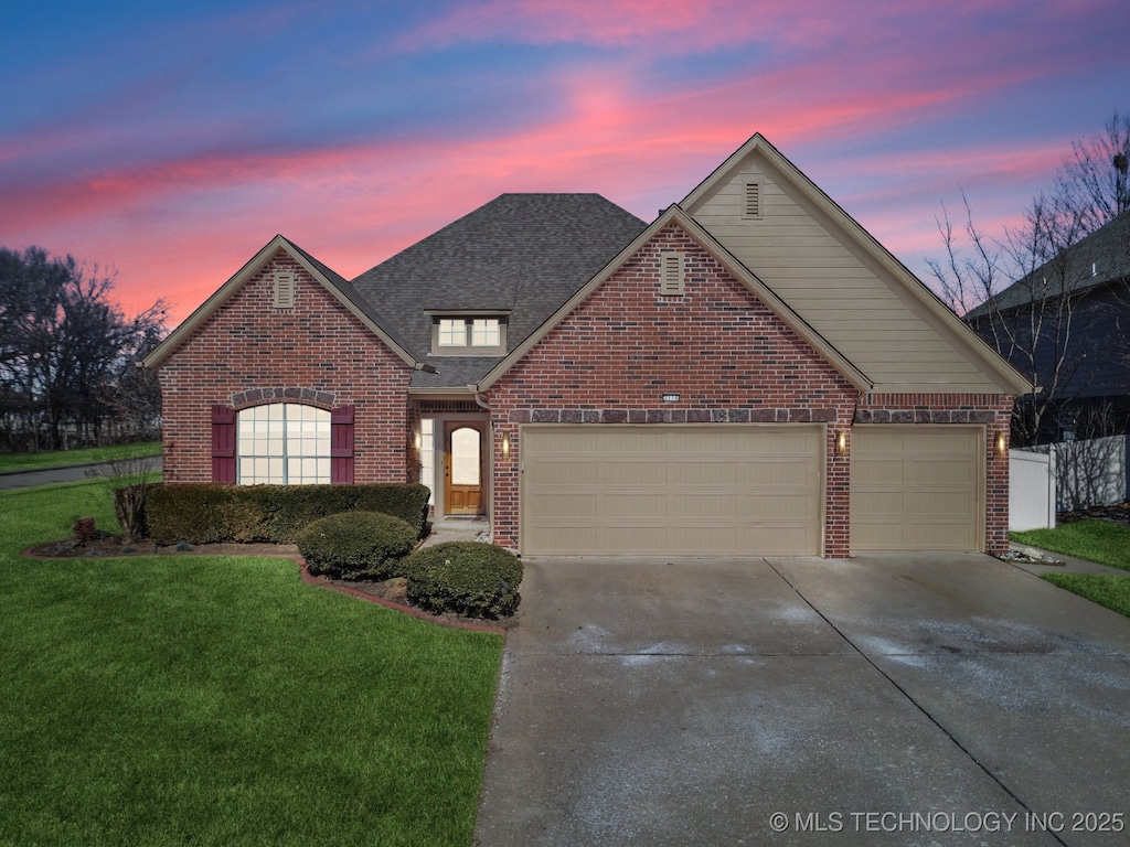 2114 W Austin Pl, Broken Arrow, OK 74011 - traditional-style house featuring a lawn, driveway, a shingled roof, a garage, and brick siding