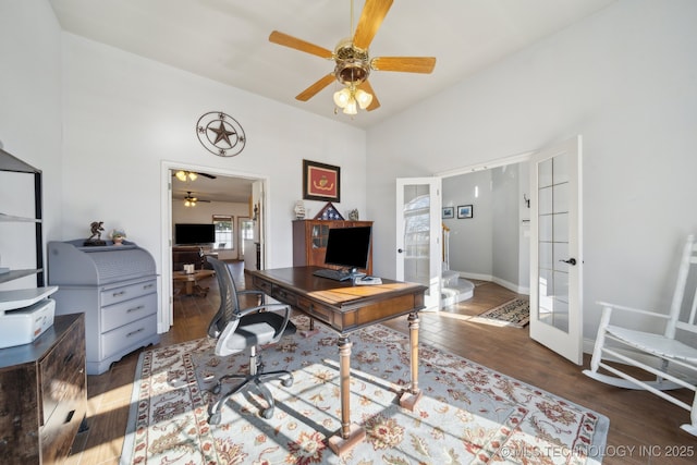 office with dark hardwood / wood-style floors, ceiling fan, and french doors