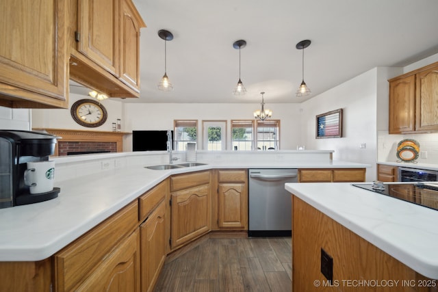 kitchen featuring dishwasher, hanging light fixtures, sink, dark hardwood / wood-style floors, and decorative backsplash