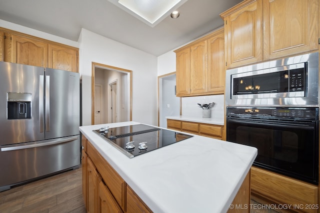 kitchen featuring backsplash, a center island, dark hardwood / wood-style flooring, and stainless steel appliances