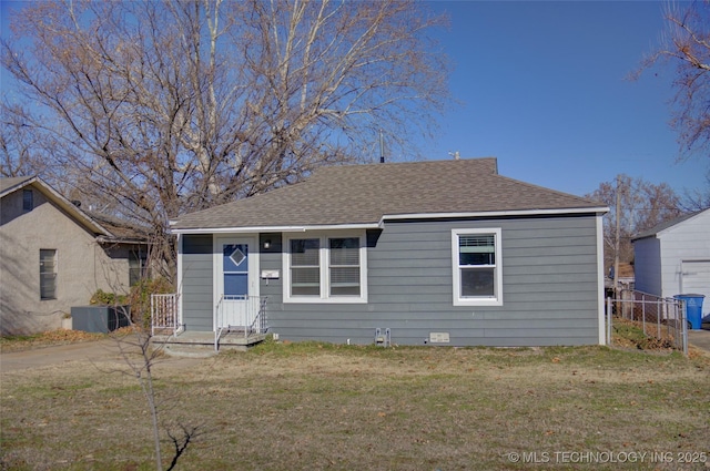 bungalow featuring central AC and a front yard