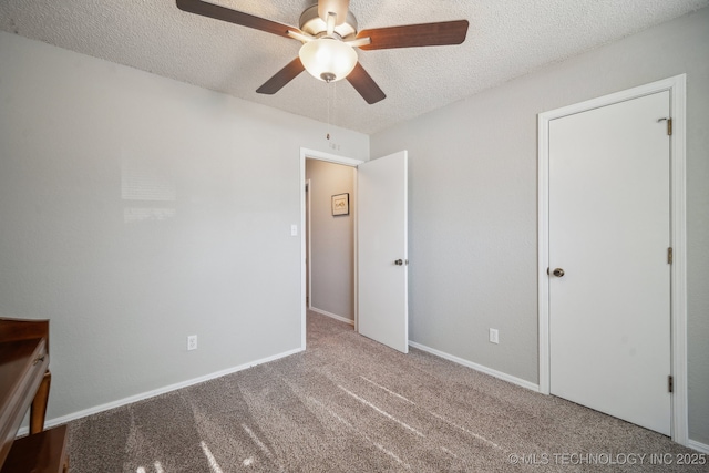 unfurnished bedroom with a textured ceiling, ceiling fan, and carpet flooring