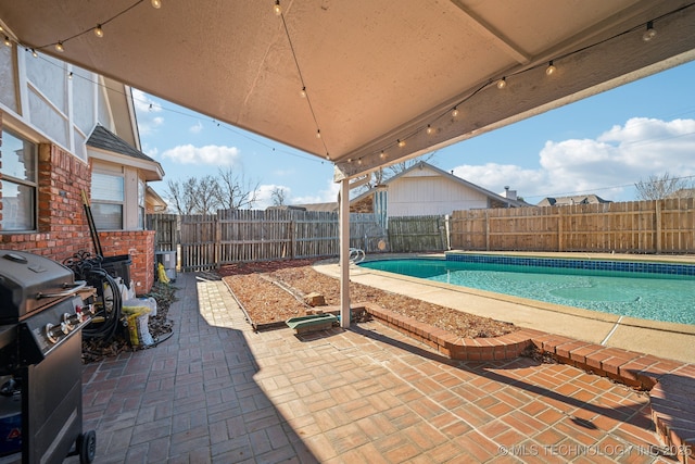 view of patio / terrace featuring area for grilling and a fenced in pool