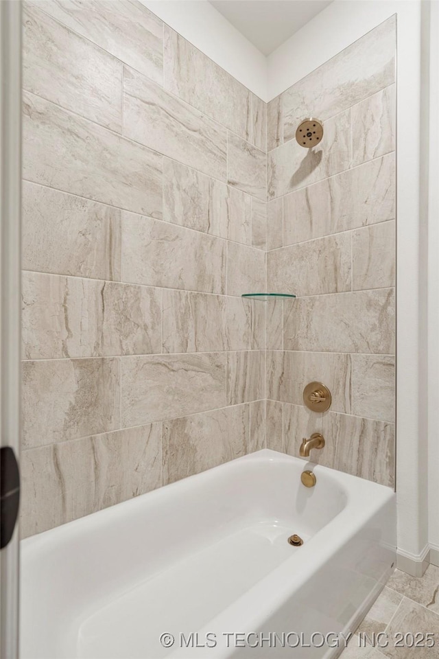 bathroom featuring tiled shower / bath combo and tile patterned floors