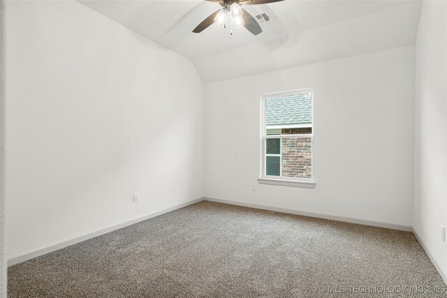 spare room with ceiling fan, carpet flooring, and lofted ceiling