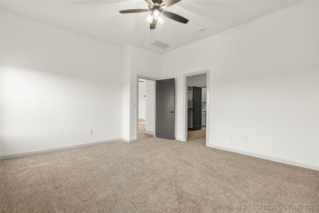 carpeted spare room with ceiling fan