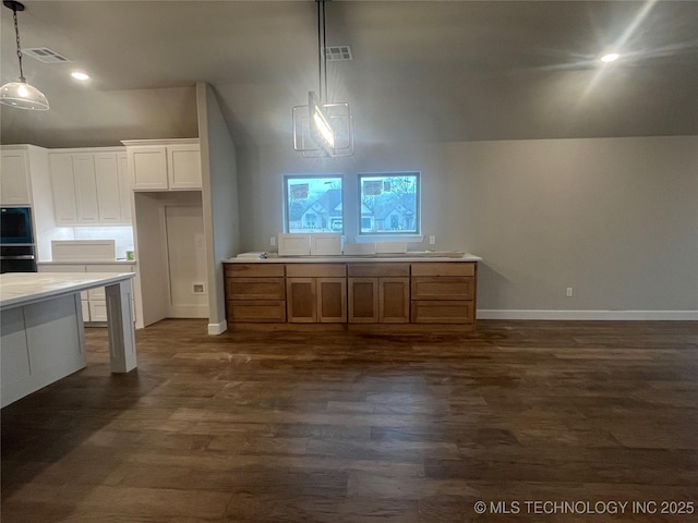 kitchen featuring white cabinetry, dark hardwood / wood-style floors, high vaulted ceiling, and pendant lighting