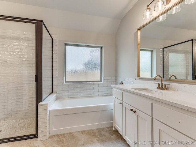 1412 N 70th St, Broken Arrow, OK 74014 - bathroom featuring a stall shower, a garden tub, vanity, vaulted ceiling, and tile patterned flooring