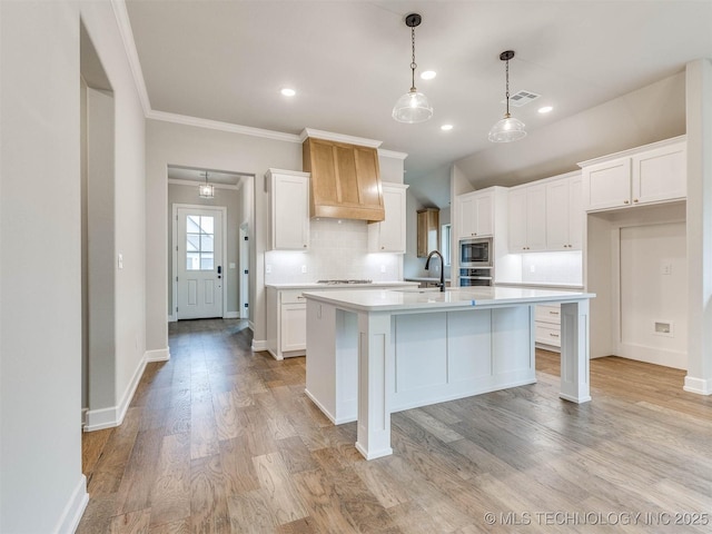 1412 N 70th St, Broken Arrow, OK 74014 - kitchen featuring appliances with stainless steel finishes, premium range hood, light countertops, tasteful backsplash, and white cabinets