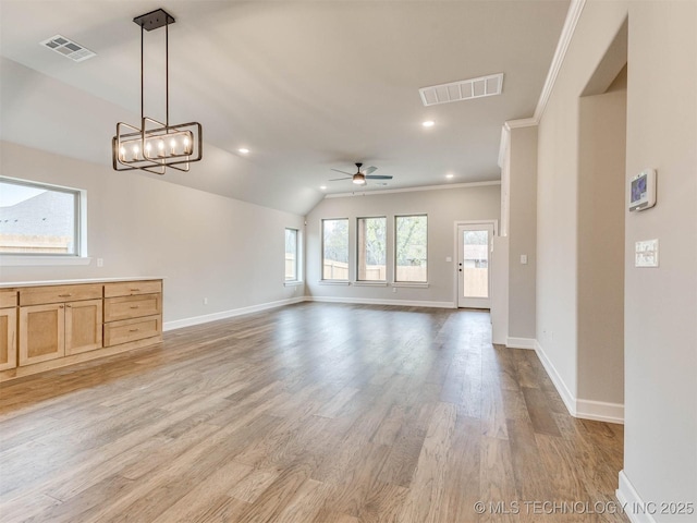 1412 N 70th St, Broken Arrow, OK 74014 - unfurnished living room featuring ceiling fan, crown molding, light wood-style floors, vaulted ceiling, and a chandelier