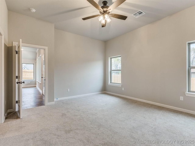 1412 N 70th St, Broken Arrow, OK 74014 - unfurnished room featuring carpet flooring, plenty of natural light, a ceiling fan, and a smoke detector