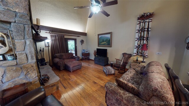 living room featuring wood-type flooring and ceiling fan