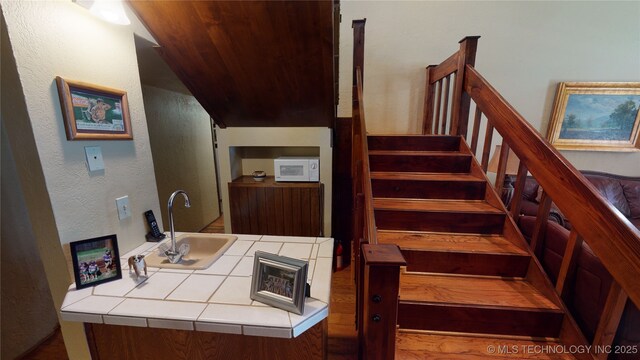 staircase with sink and wood ceiling