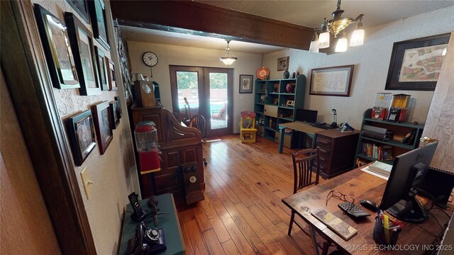 office space featuring an inviting chandelier and hardwood / wood-style floors