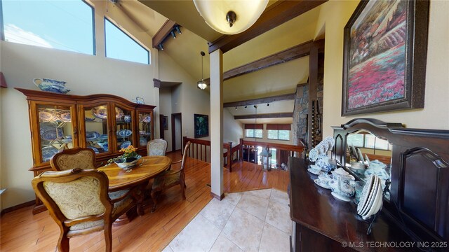 tiled dining room with high vaulted ceiling