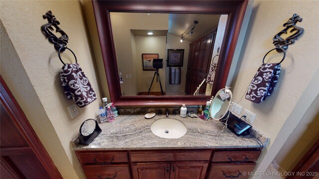 bathroom featuring vanity and lofted ceiling