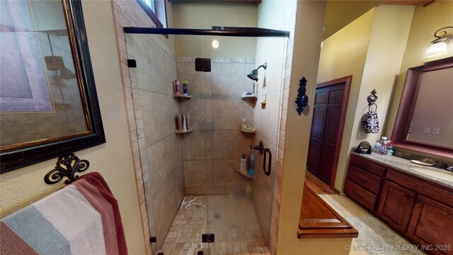 bathroom featuring vanity and an enclosed shower