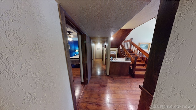 hall with a textured ceiling