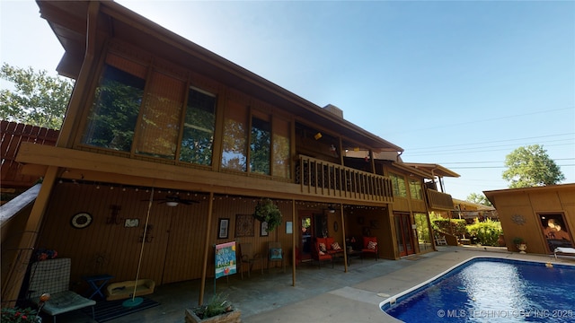 rear view of house featuring a patio area and ceiling fan