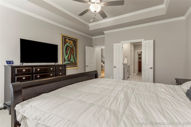 carpeted bedroom featuring ceiling fan, crown molding, and a tray ceiling