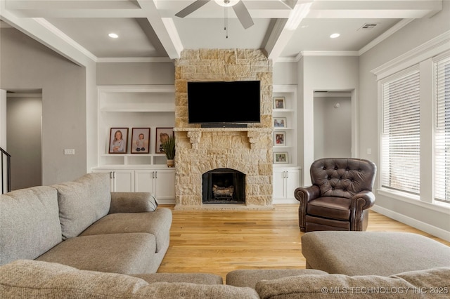 living room with beamed ceiling, a fireplace, light hardwood / wood-style floors, built in features, and coffered ceiling