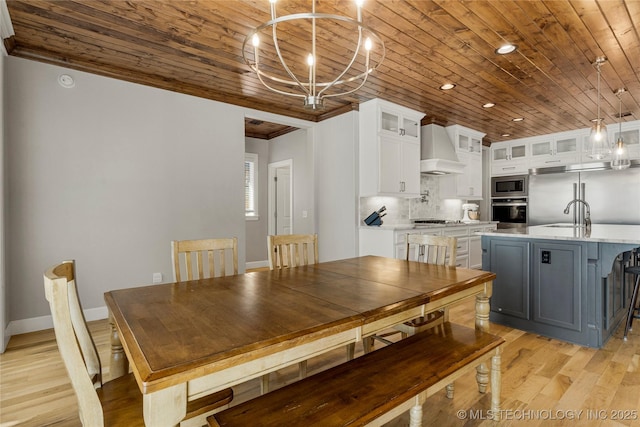 unfurnished dining area featuring wood ceiling, crown molding, a notable chandelier, and light wood-type flooring