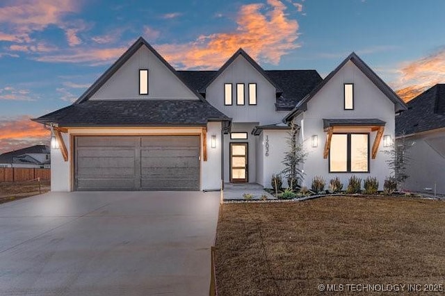 view of front of house featuring driveway, a shingled roof, a front yard, and stucco siding