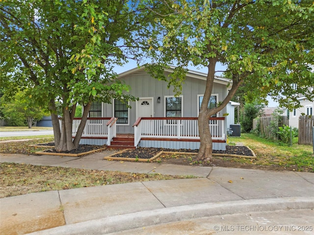 view of front of property with covered porch and central AC unit