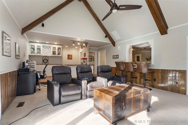 interior space with indoor bar, wood walls, and high vaulted ceiling