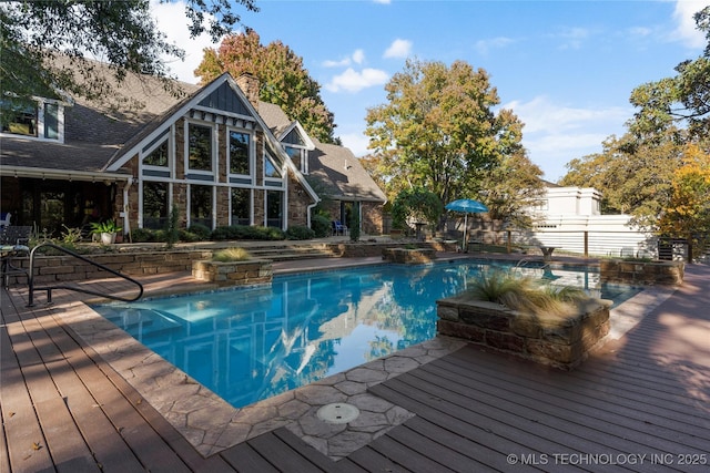 view of swimming pool with a wooden deck