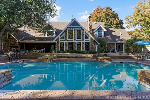 view of swimming pool with a patio