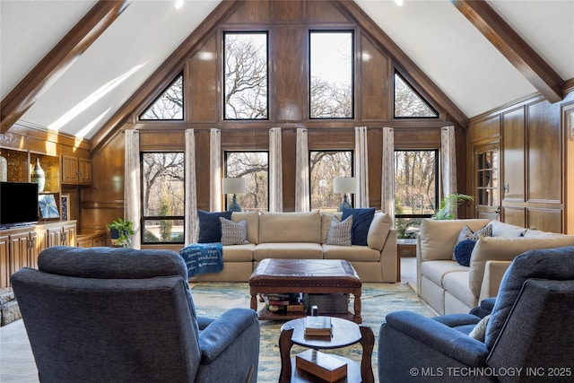 living room featuring high vaulted ceiling, wood walls, and beamed ceiling