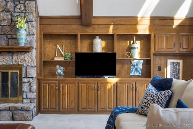 living room with built in shelves and beamed ceiling