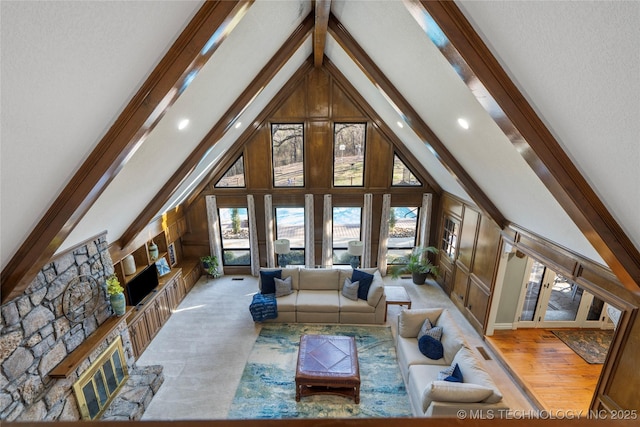 living room with high vaulted ceiling and wooden walls