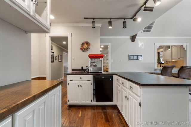 kitchen with rail lighting, white cabinets, dishwasher, and kitchen peninsula