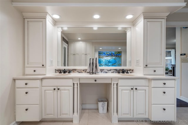 bathroom with tasteful backsplash, tile patterned flooring, and vanity