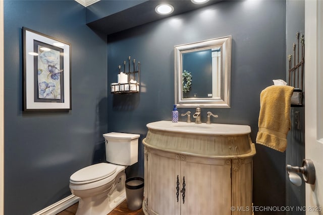 bathroom featuring toilet and vanity