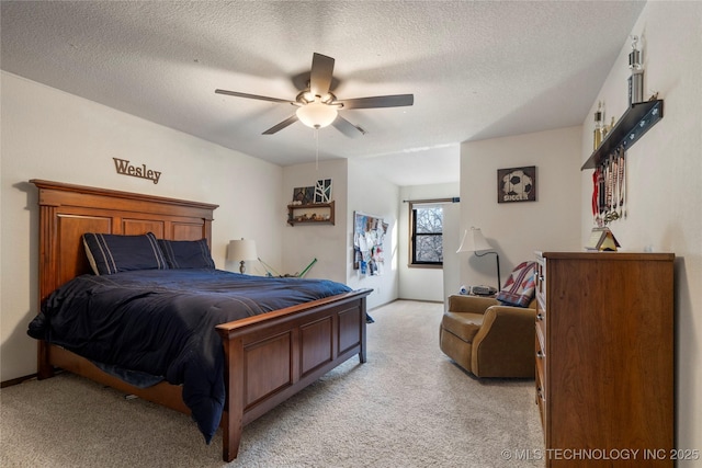 bedroom featuring ceiling fan, light colored carpet, and a textured ceiling