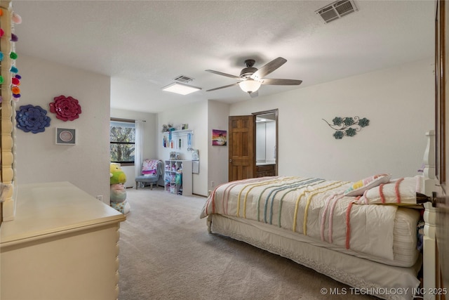 carpeted bedroom featuring ceiling fan and a textured ceiling