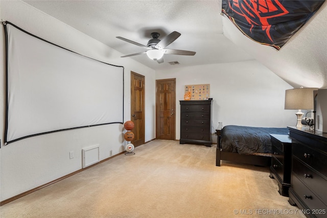 bedroom featuring ceiling fan, a textured ceiling, lofted ceiling, and light carpet