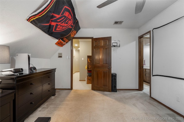 carpeted bedroom featuring lofted ceiling, connected bathroom, and ceiling fan