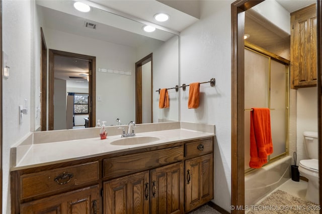 full bathroom with vanity, toilet, and combined bath / shower with glass door