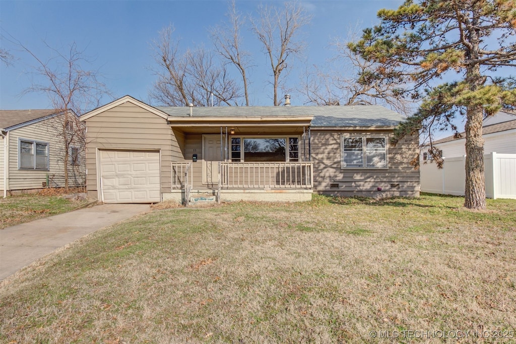 view of front of house featuring a porch, a garage, and a front yard