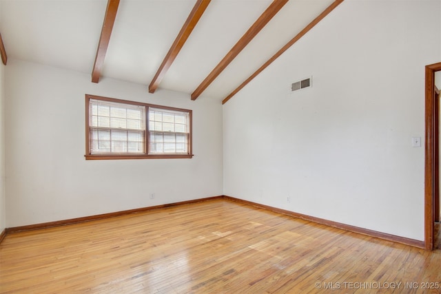 empty room featuring light hardwood / wood-style floors, beam ceiling, and high vaulted ceiling