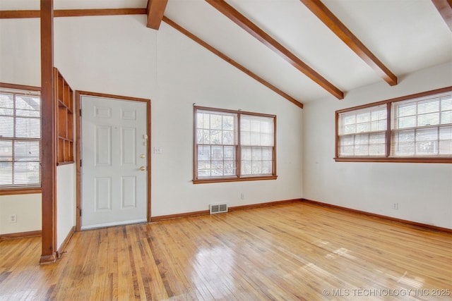 foyer entrance featuring light hardwood / wood-style floors, beam ceiling, and high vaulted ceiling